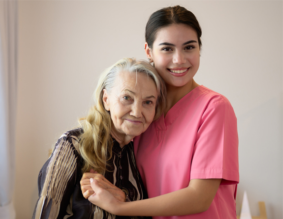 woman and a caregiver smiling
